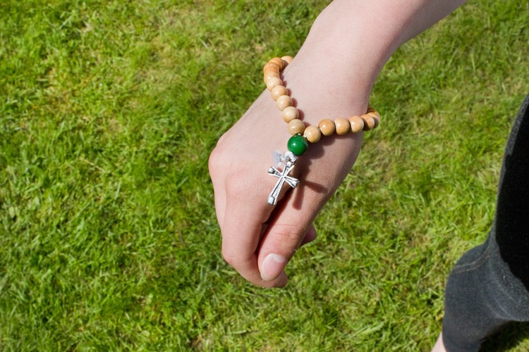 Person wearing a Christian prayer bracelet.