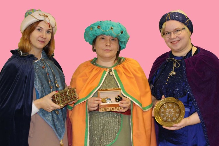 Kolme Tietäjien messun näyttelijää sonnustautuneina itämaan tietäjiksi.